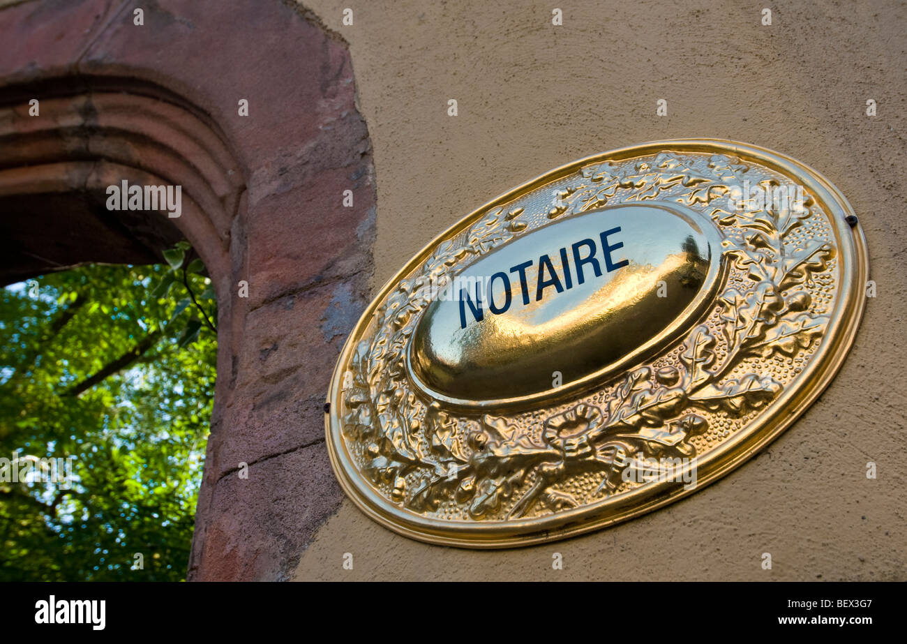 Moulded polished brass plaque sign depicting official french 'Notaire' office in France Stock Photo