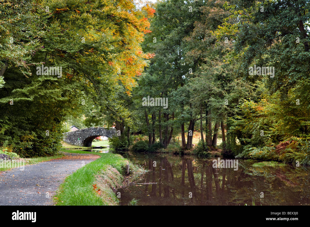 Old stone bridge 134 on the Monmouth and Brecon Canal taken at Llangynidr mid Wales early autumn with perfect still reflection Stock Photo