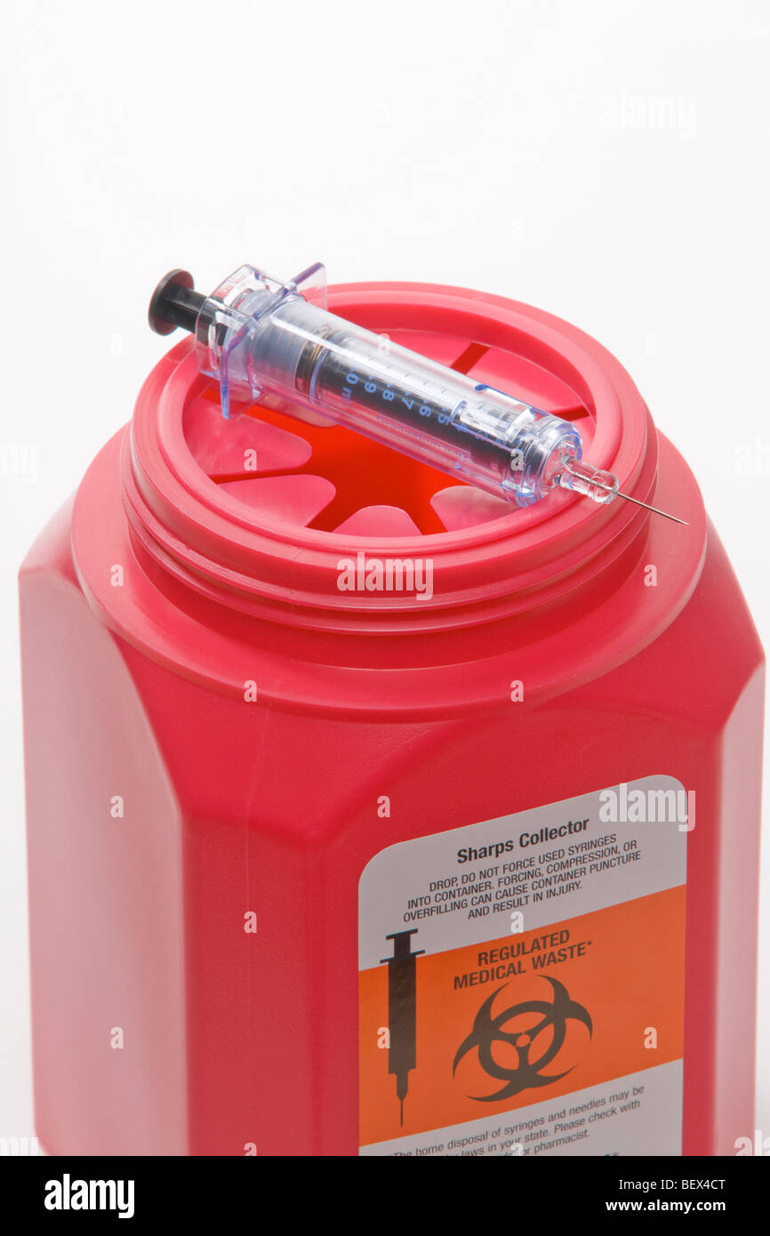 sharps collector with single use syringe Stock Photo Alamy