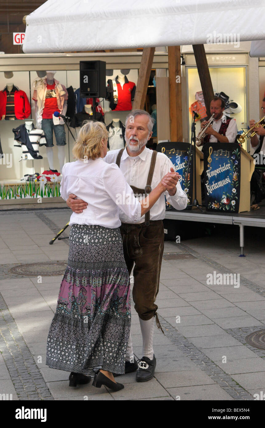 An older couple dancing on a street, Munich, Germany Stock Photo