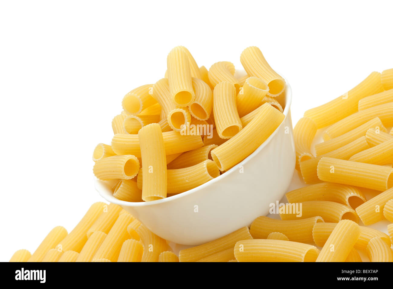 Rigatoni pasta in bowl on white background Stock Photo