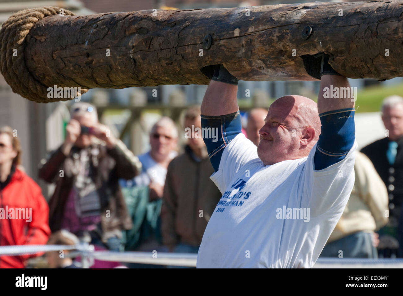 Strongman lifting log at Galloway Gathering Stock Photo