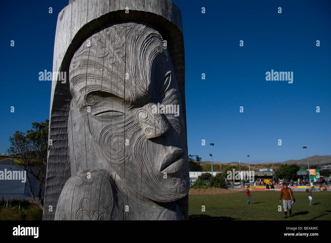 A wood carving of a Maori face, engraved with Moko, traditional skin carving, in Wellington New Zealand Stock Photo