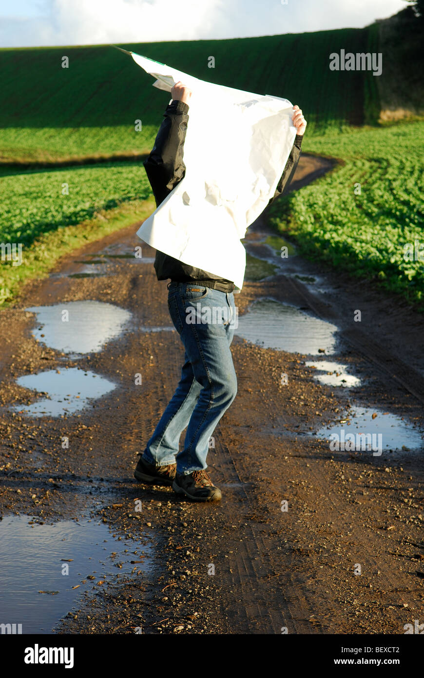 Man Reading Map in Windy Weather. Stock Photo