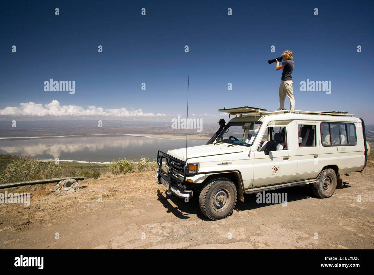 Photographer standing on safari vehicle - Lake Nakuru National Park, Kenya Stock Photo