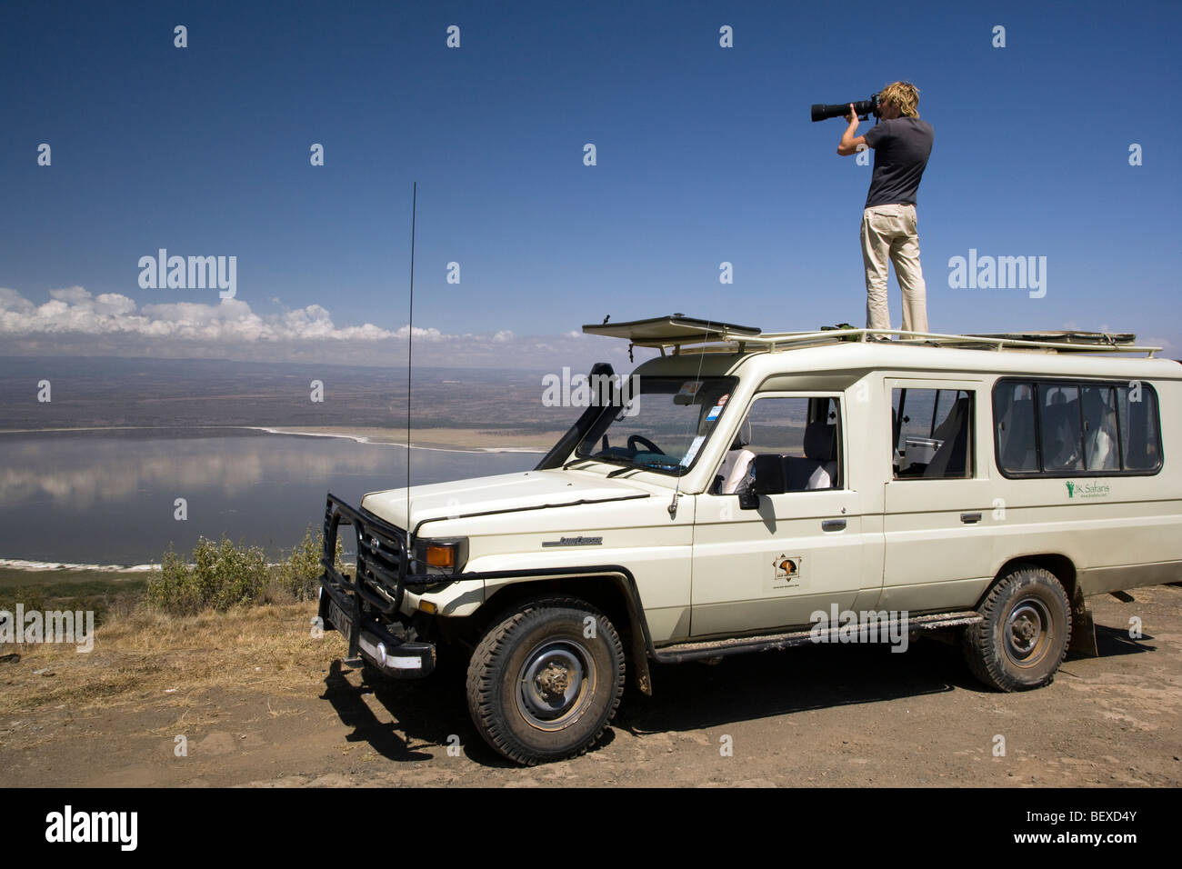 Photographer standing on safari vehicle - Lake Nakuru National Park, Kenya Stock Photo