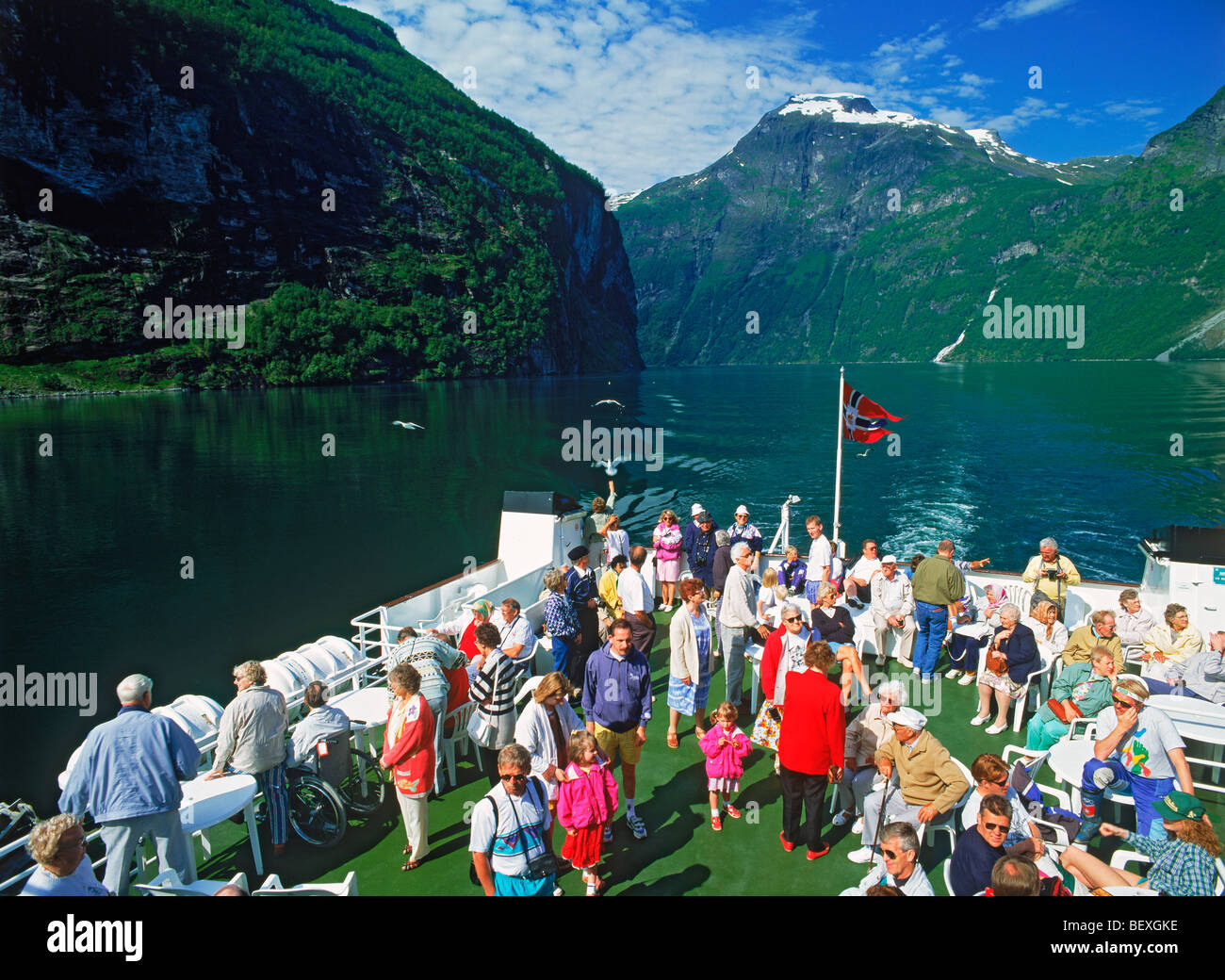 Passengers on deck of car ferry during scenic tour of Geirangerfjord in Norway Stock Photo