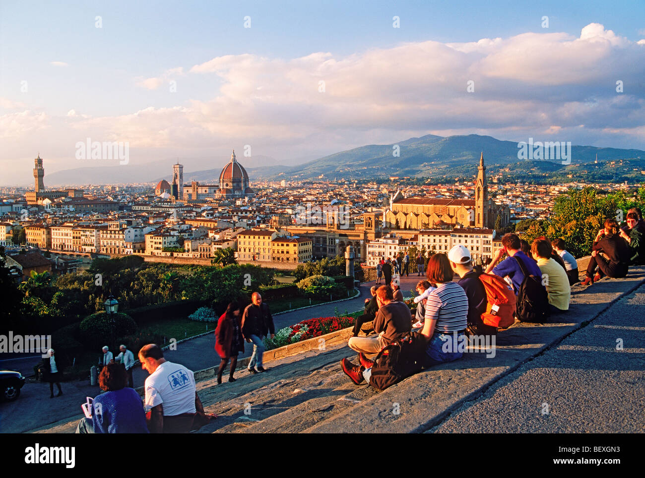 People resting on steps at Piazzale Michelangelo above Arno River and Florence near sunset Stock Photo