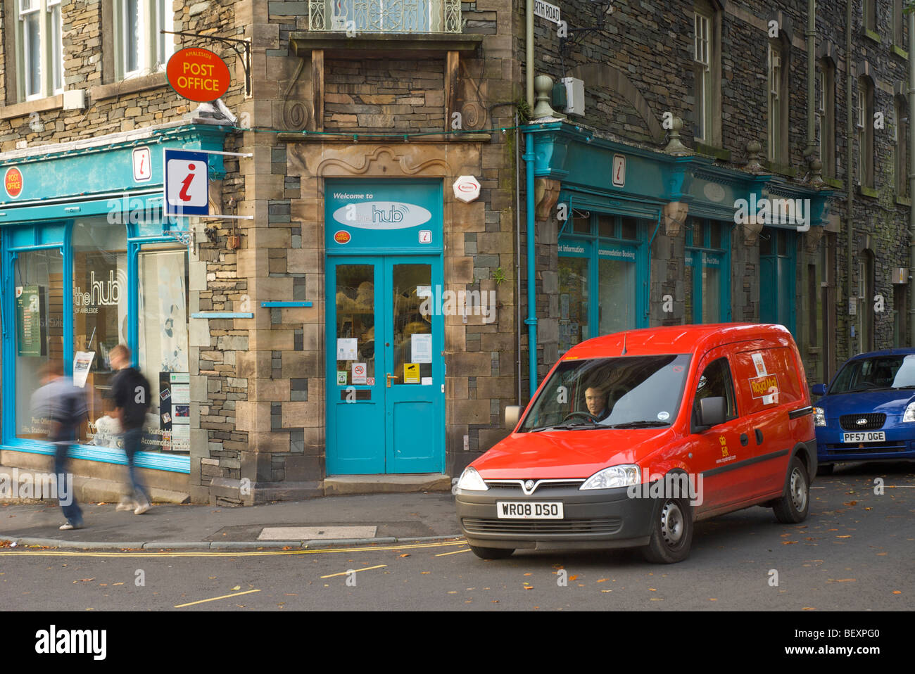Postman in royal mail van outside post office, Ambleside, Cumbria