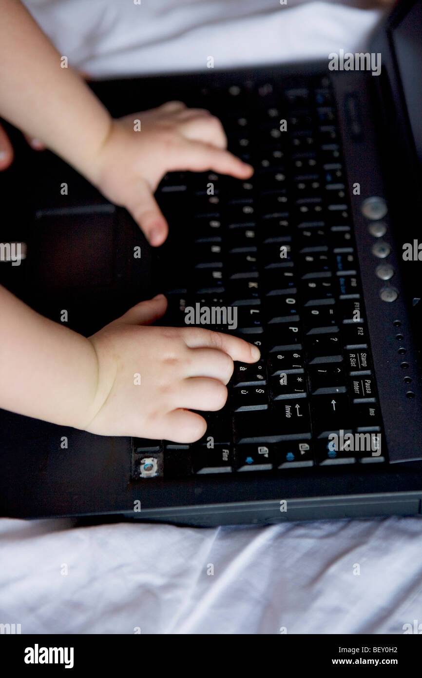 child's hands on the keyboard Stock Photo