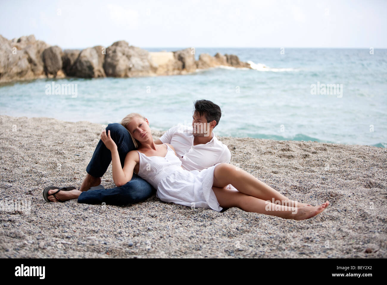 young couple lying on the beach Stock Photo - Alamy