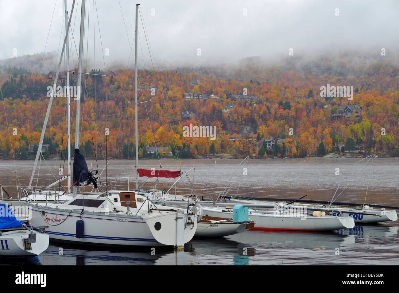 Sailboat marina on Mt. Tremblant Lake with clouds and mist with a