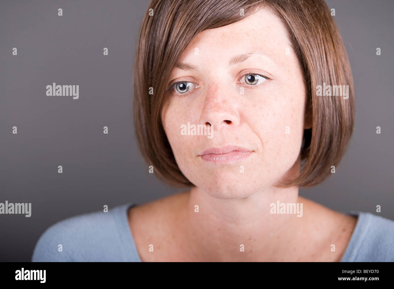 Beautiful Middle-aged woman in thoughtful mode Stock Photo
