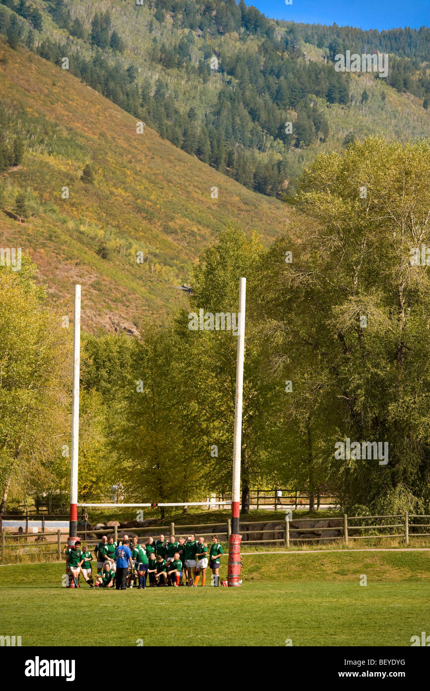 Aspen Colorado 42nd Annual Ruggerfest. Rugby team posing for a group shot after the game, against a backdrop of ski slopes. Stock Photo