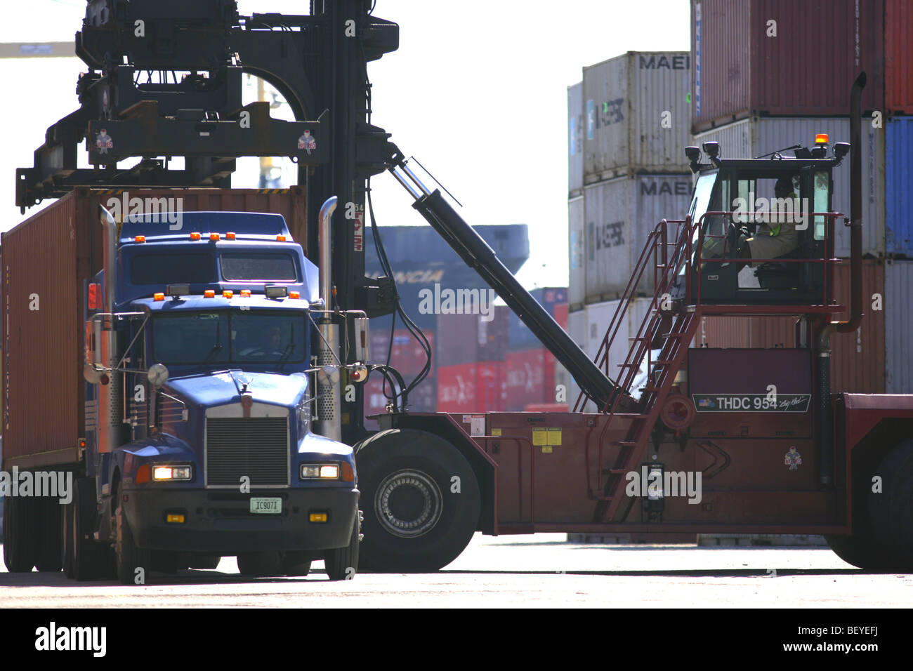 Loading containership in port Stock Photo - Alamy