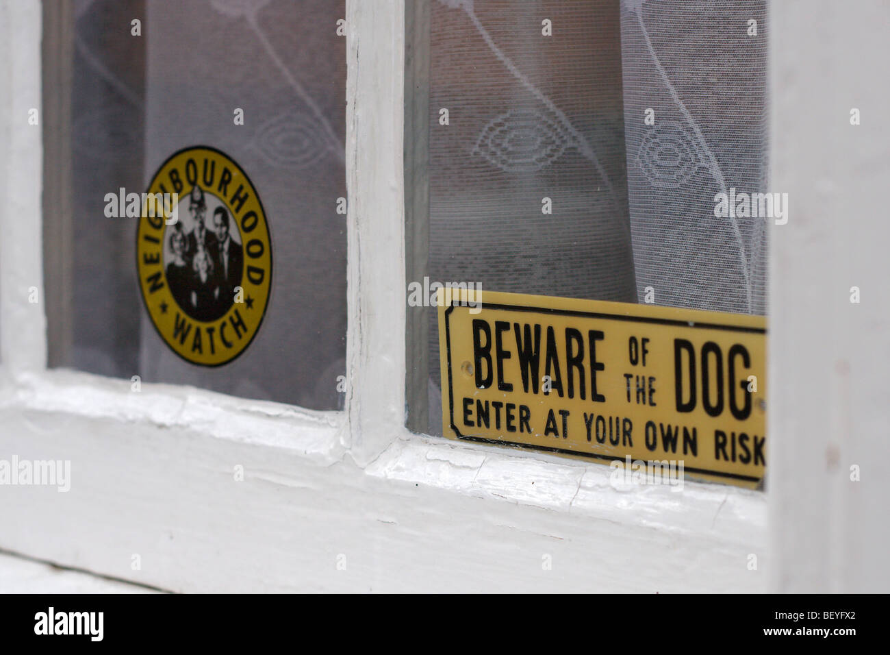 Security signs in a house window Stock Photo