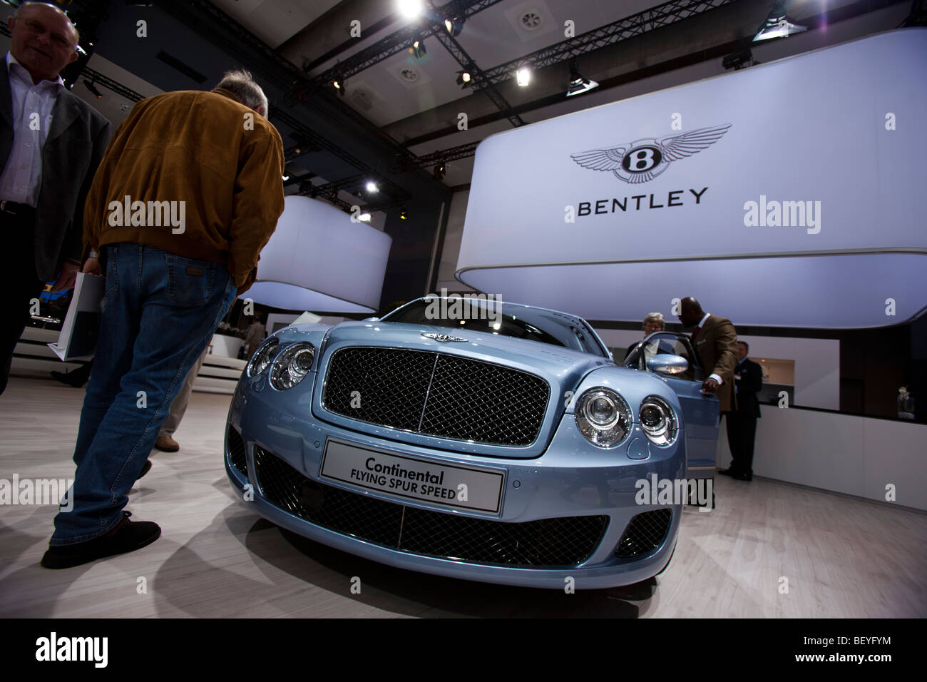A visitor looks at a Bentley Continental Flying Spur Speed an automobile show of the Volkswagen AG in Hamburg, Germany. Stock Photo