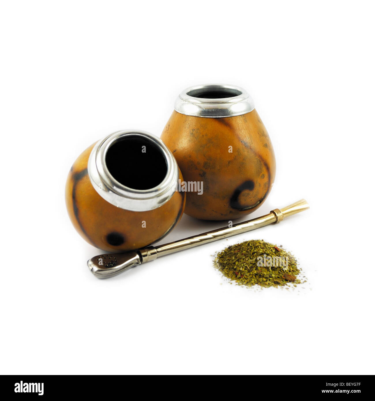 Two mate gourds, bombilla and handful of yerba mate Stock Photo