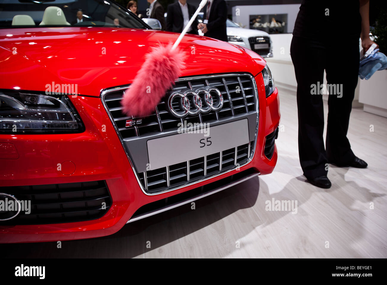 An employee cleans an Audi S5 automobile at Volkswagen AG's annual shareholders' meeting in Hamburg, Germany. Stock Photo