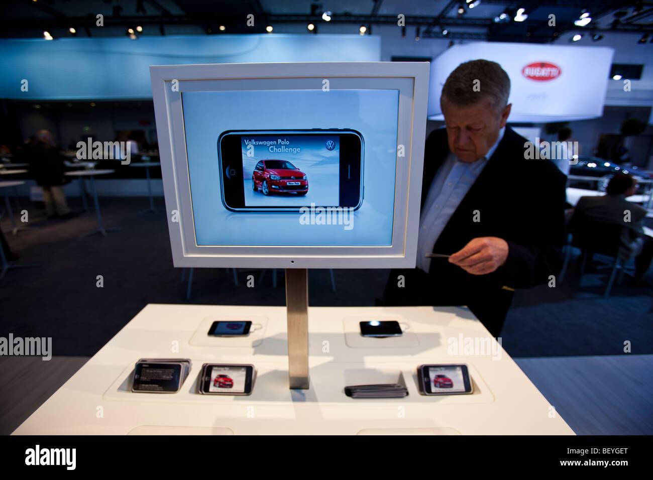 A visitor looks at VW iPod App an automobile show of the Volkswagen AG in Hamburg, Germany. Stock Photo