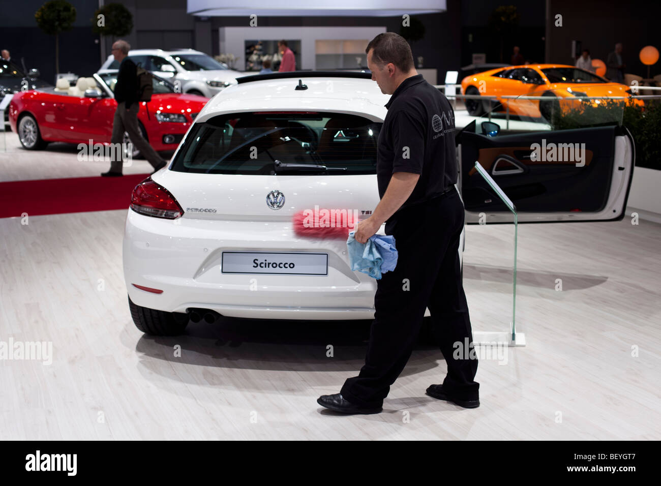An employee cleans a Volkswagen Scirocco at an automobile show of the Volkswagen AG in Hamburg, Germany. Stock Photo