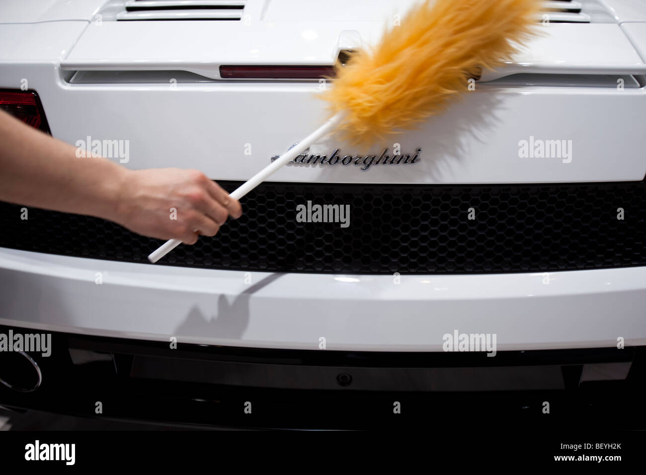 An employee cleans an Lamborghini automobile at Volkswagen AG's annual shareholders' meeting in Hamburg, Germany. Stock Photo