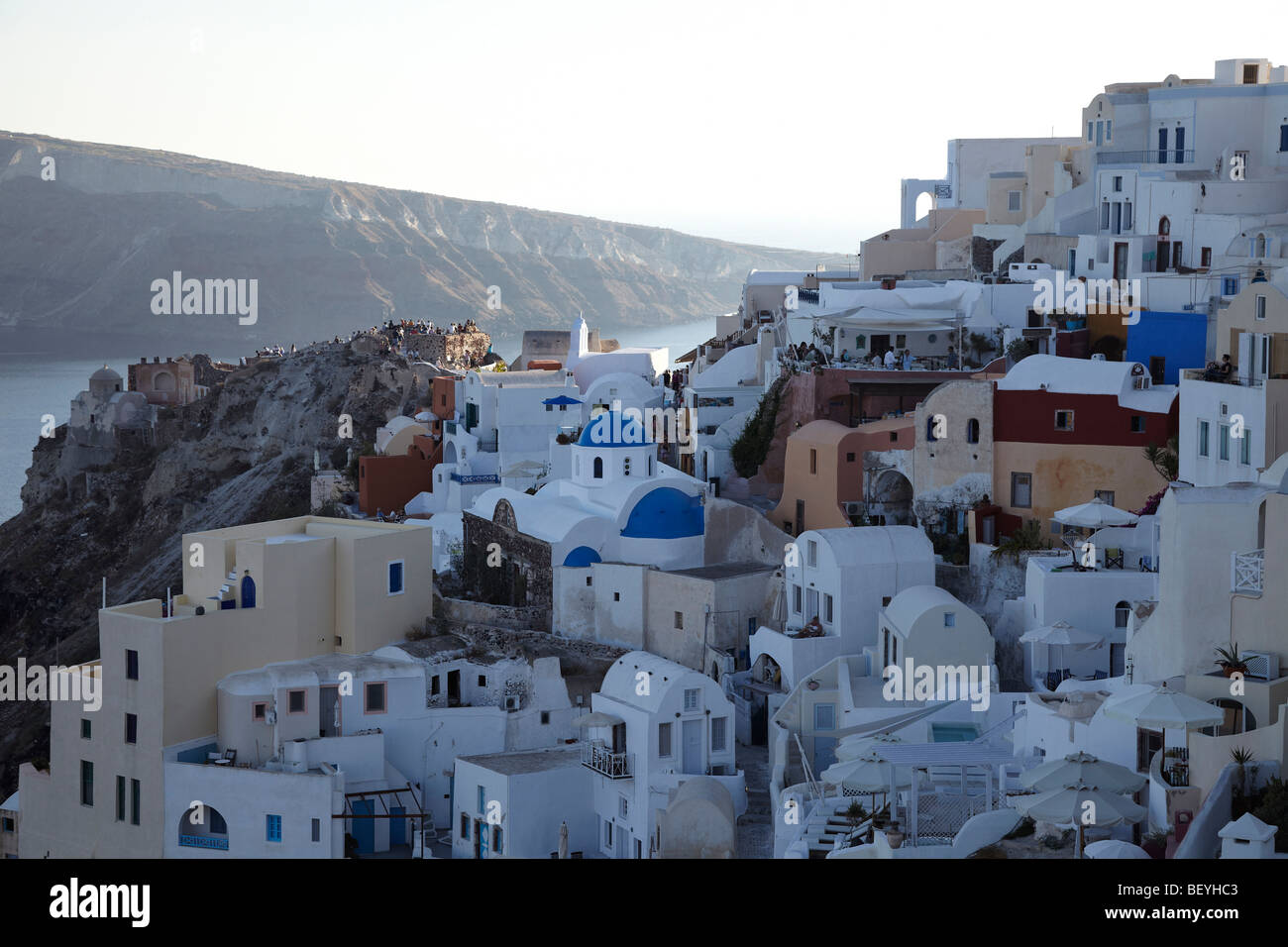 View over the village of Oia and people waiting for the sunset, Santorini, Cyclades Islands, Greece Stock Photo