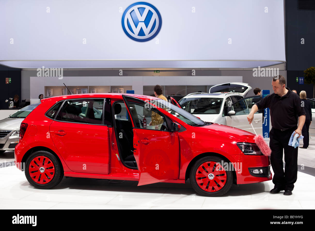 An employee cleans a Polo BlueMotion at an automobile show of the Volkswagen AG in Hamburg, Germany. Stock Photo