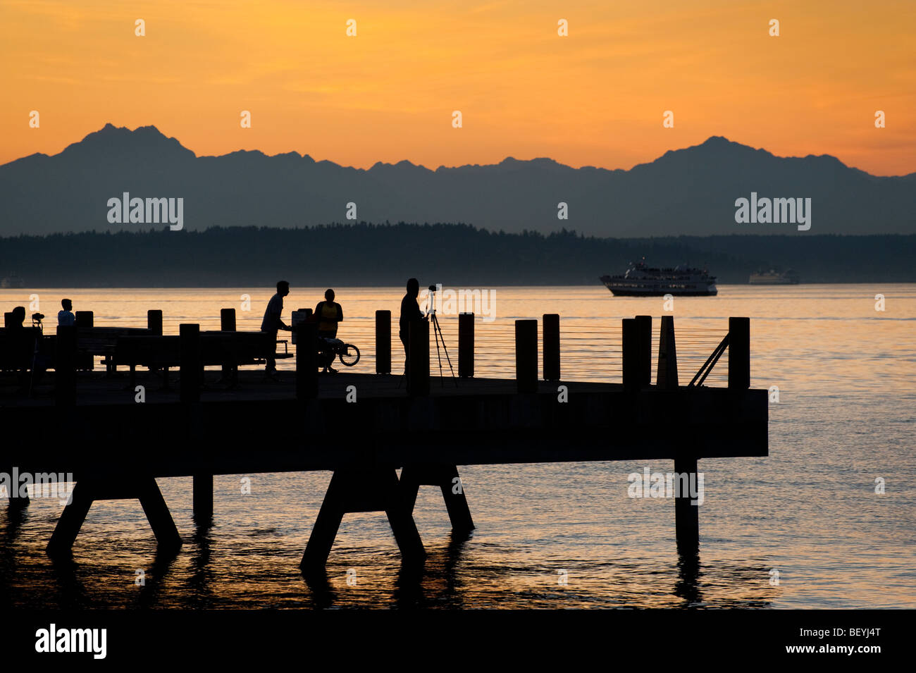 On Alki Beach in West Seattle, Washington, the sun sets over the ...