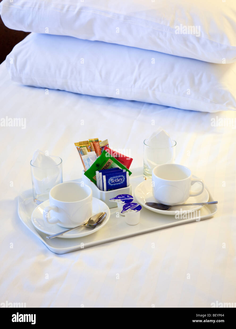 Tea and coffee tray on a hotel room bed Stock Photo