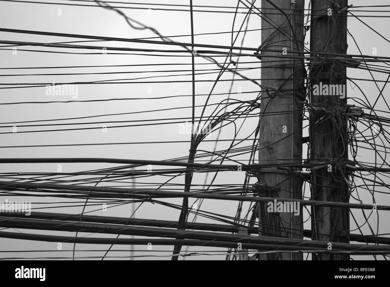 Tangled telephone and power lines on telegraph poles. Passi City Iloilo Philippines Stock Photo
