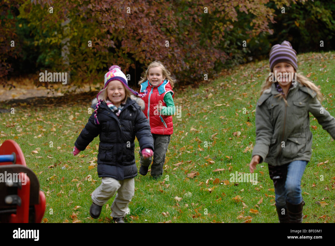 Girls playing in autumn Stock Photo - Alamy