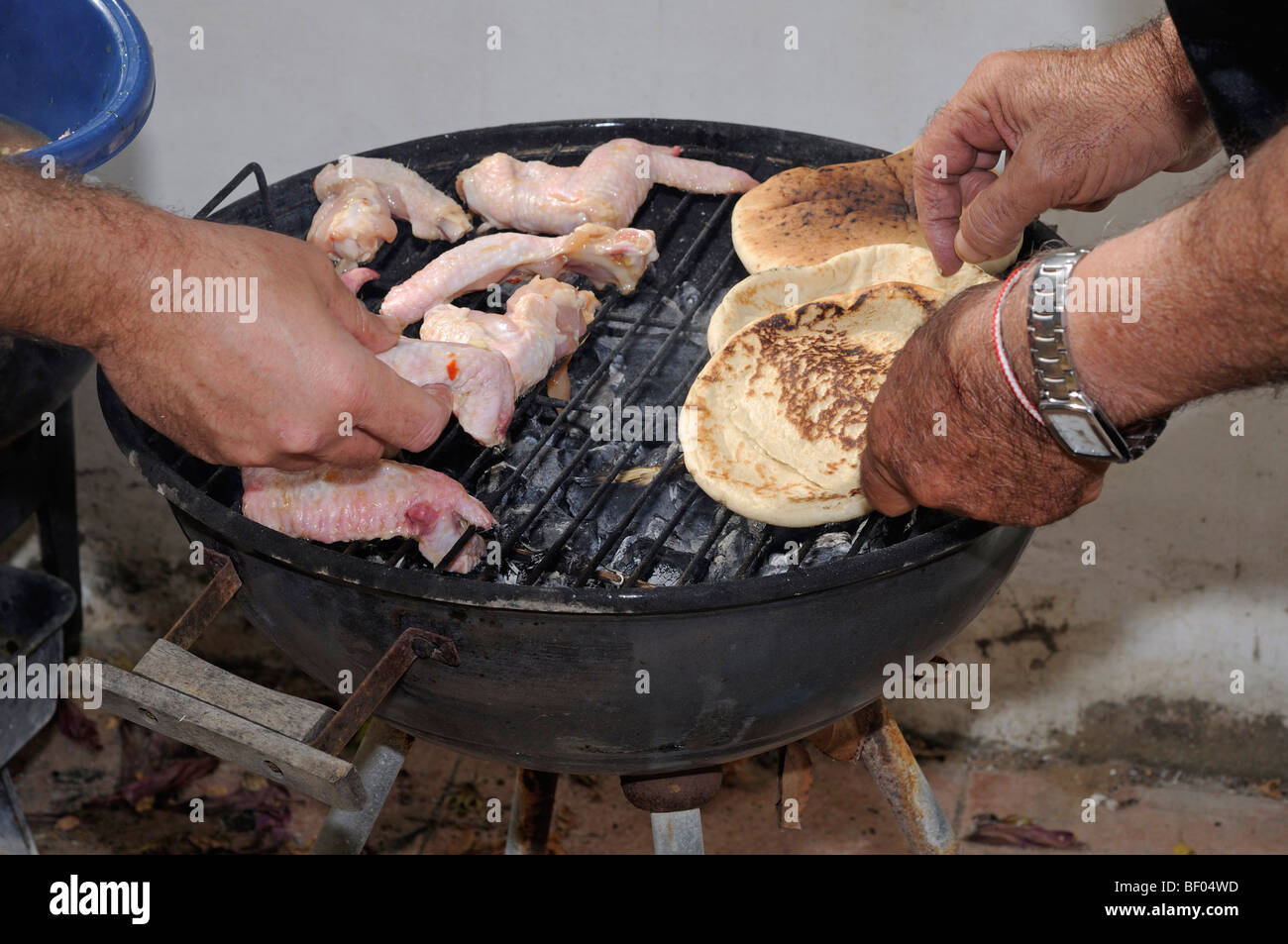 Cooking chicken wings on a barbecue Stock Photo