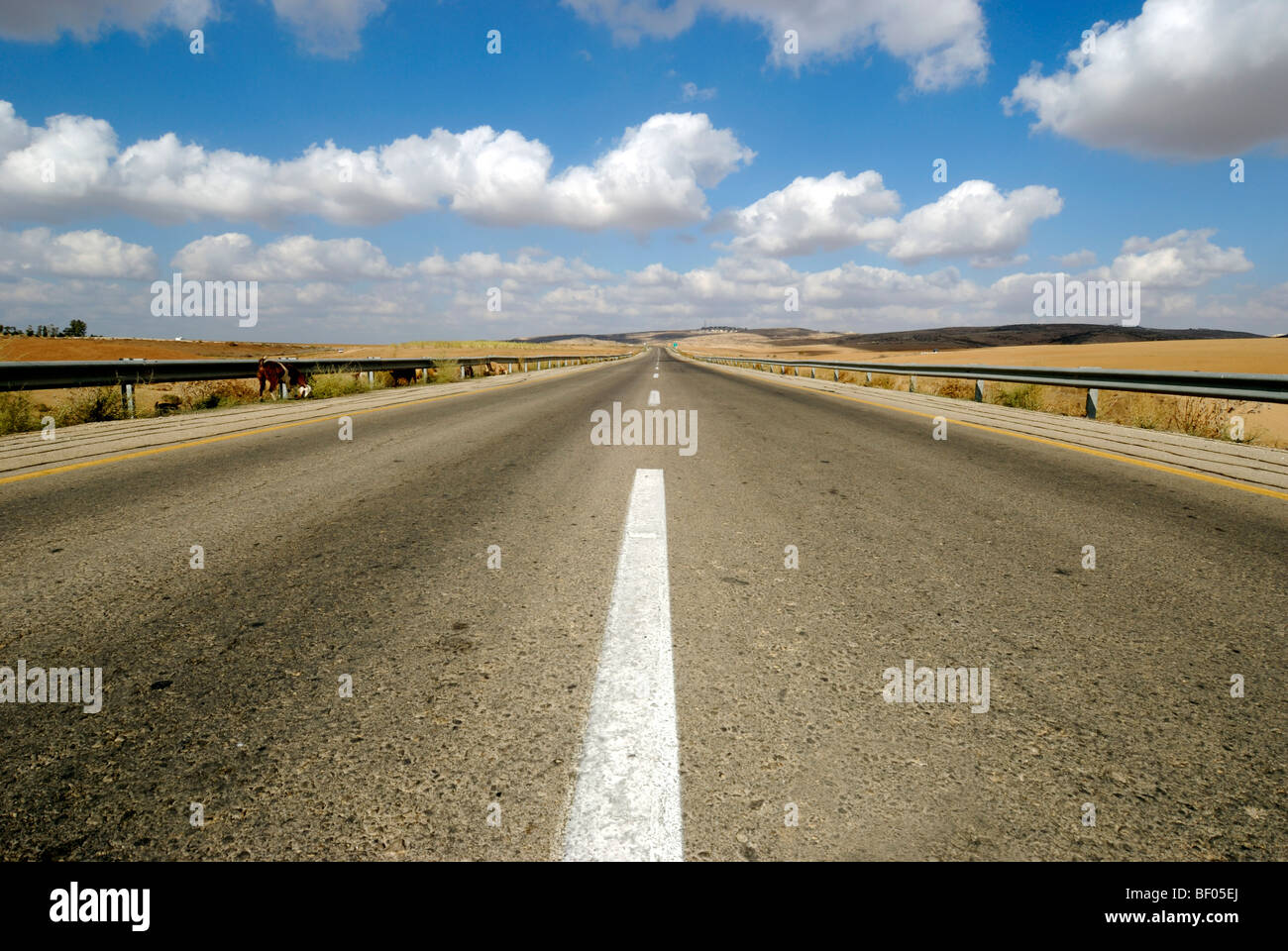 Australian, western New South Wales, Endless road to nowhere running into the horizon blue sky with clouds Stock Photo