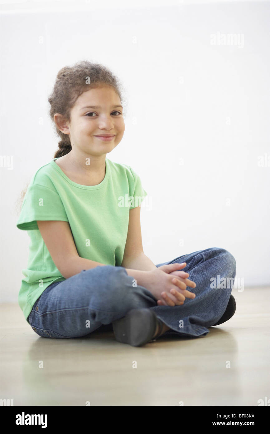 Portrait of a girl sitting on the floor Stock Photo - Alamy