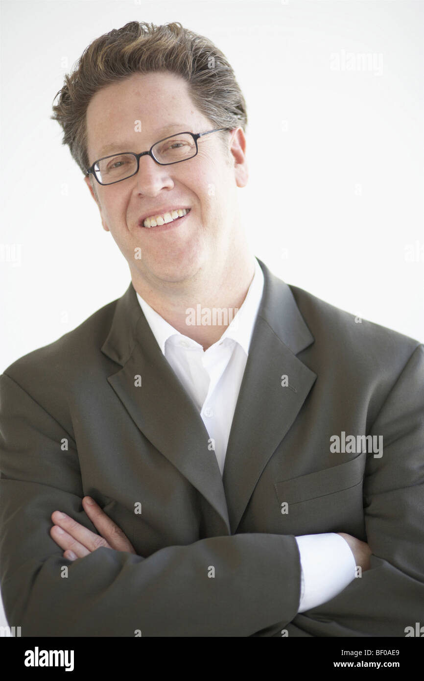 Portrait of a businessman with his arms crossed smiling Stock Photo - Alamy
