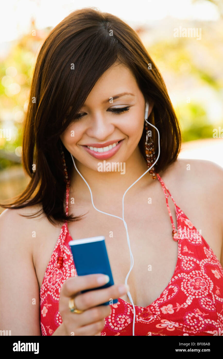 Woman listening to an MP3 player Stock Photo