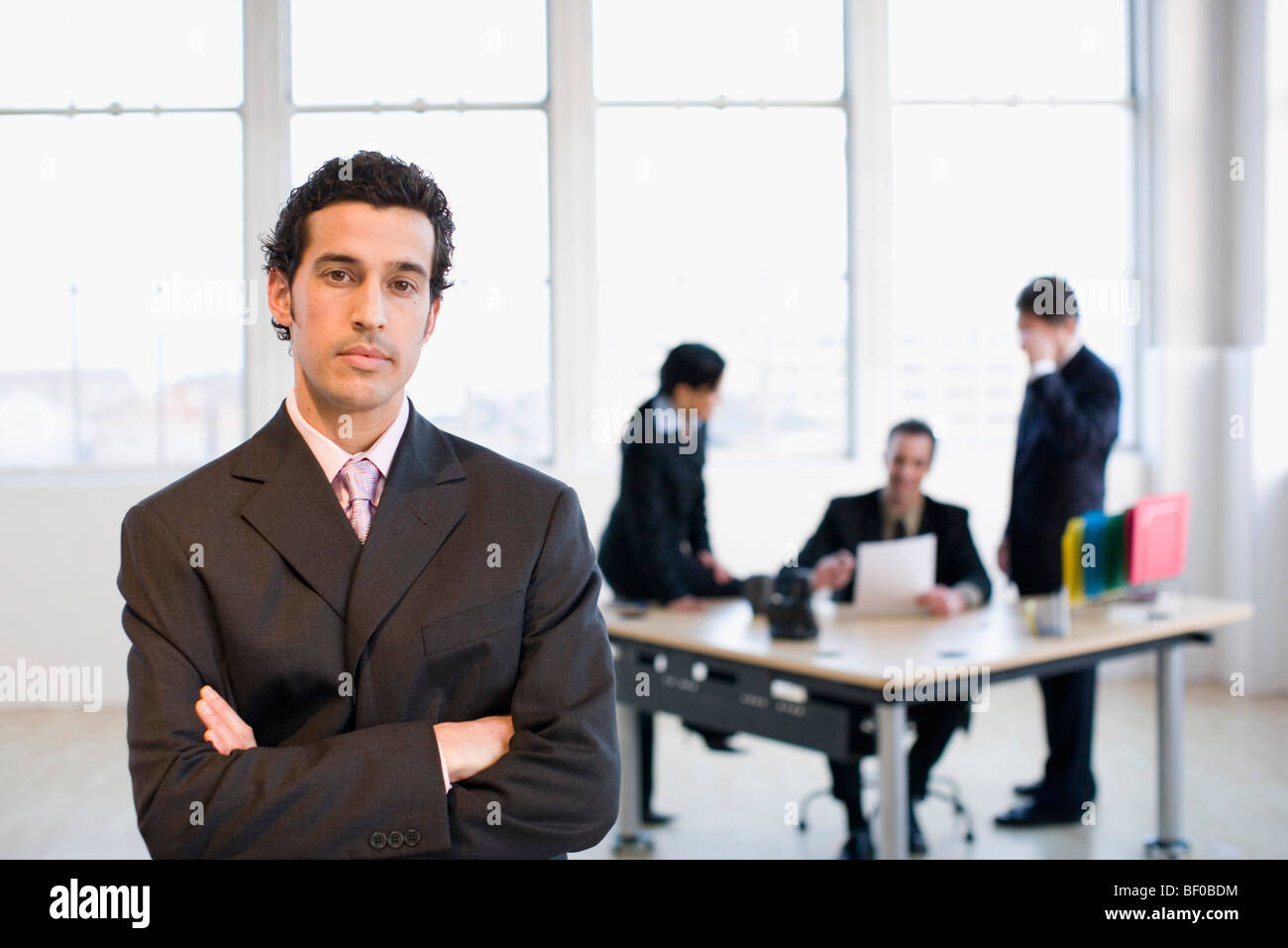 Businessman with his arms crossed in an office Stock Photo - Alamy