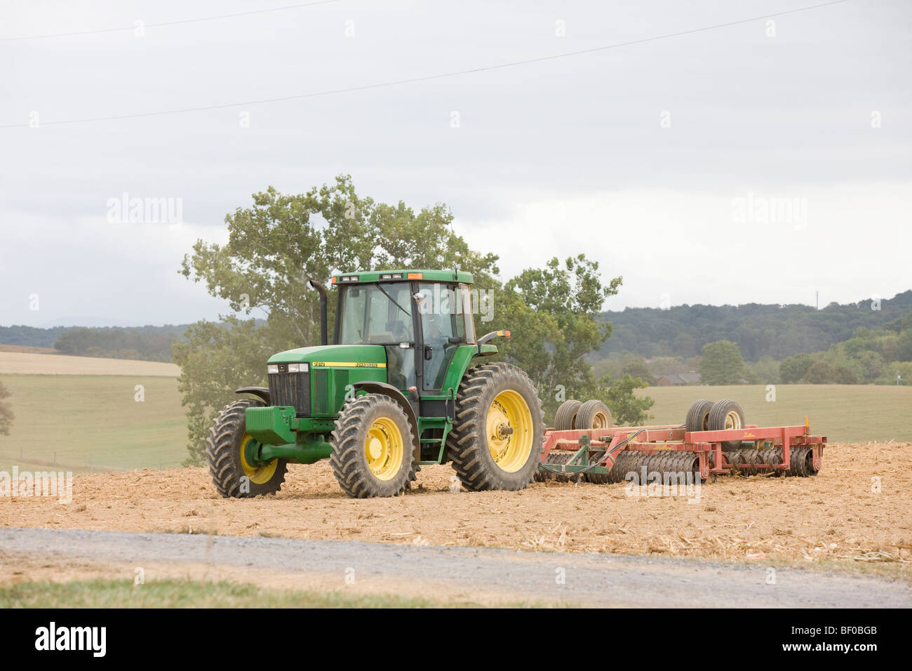 A farmer uses his tractor to work the field in Staunton, Virginia. Stock Photo