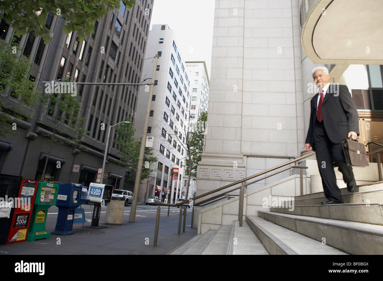 Low angle view of a businessman moving down a staircase Stock Photo