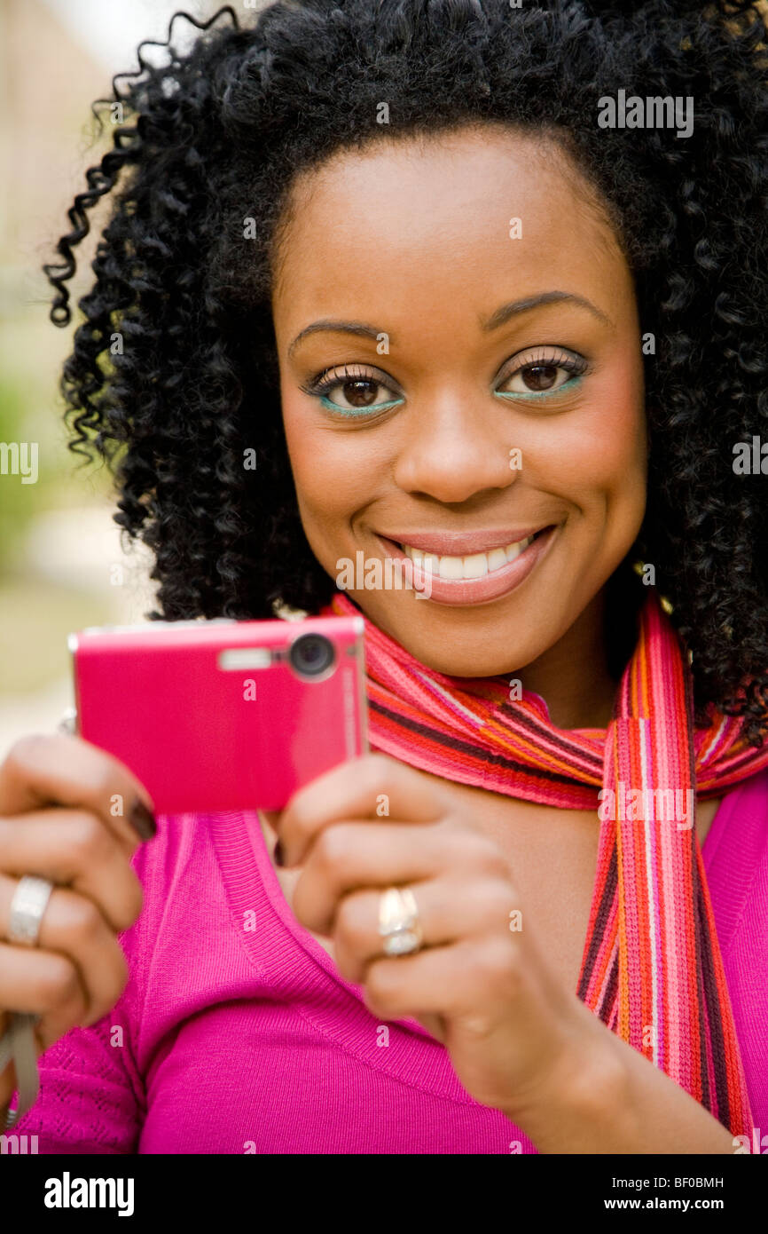 Woman taking a picture with a mobile phone Stock Photo