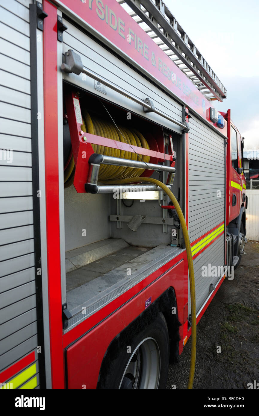 Fire Engine side locker open with Hosereel laid out Stock Photo