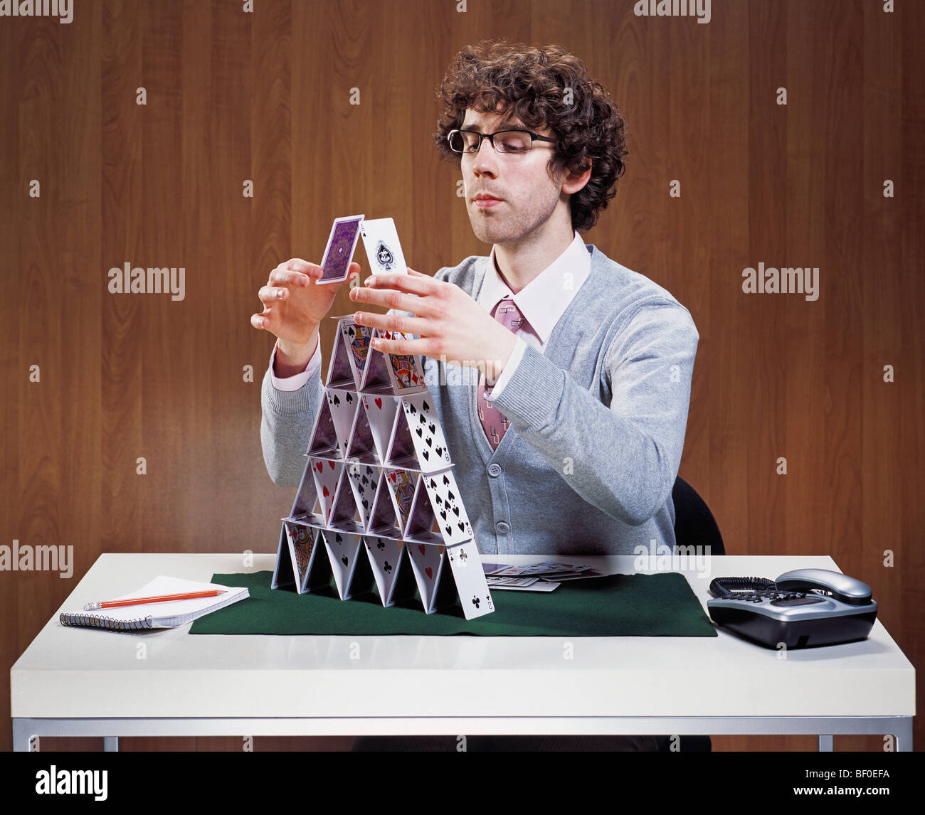 Businessman stacking cards on desk Stock Photo Alamy
