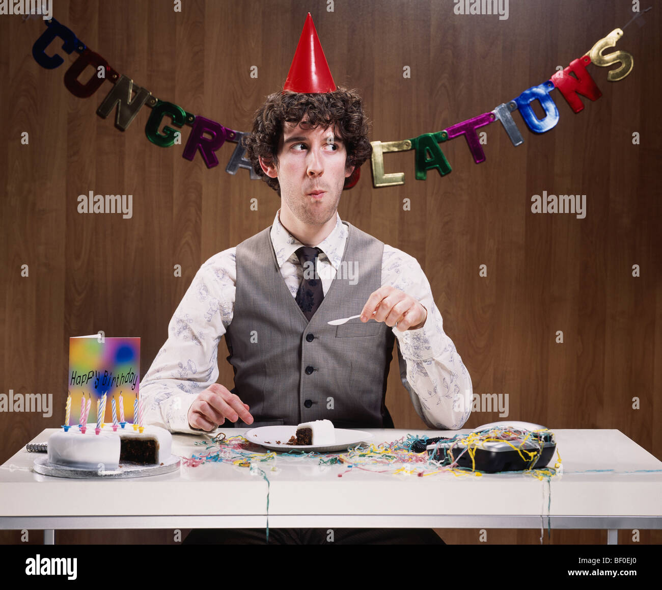Businessman eating birthday cake Stock Photo Alamy