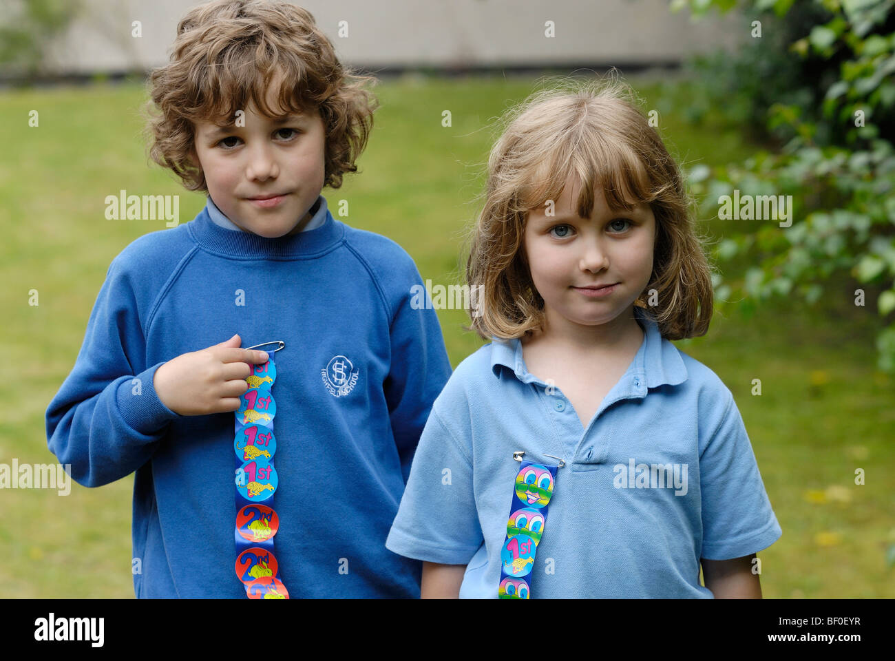 Boy and Girl winning first in race on school sports day . FULLY MODEL RELEASED Stock Photo