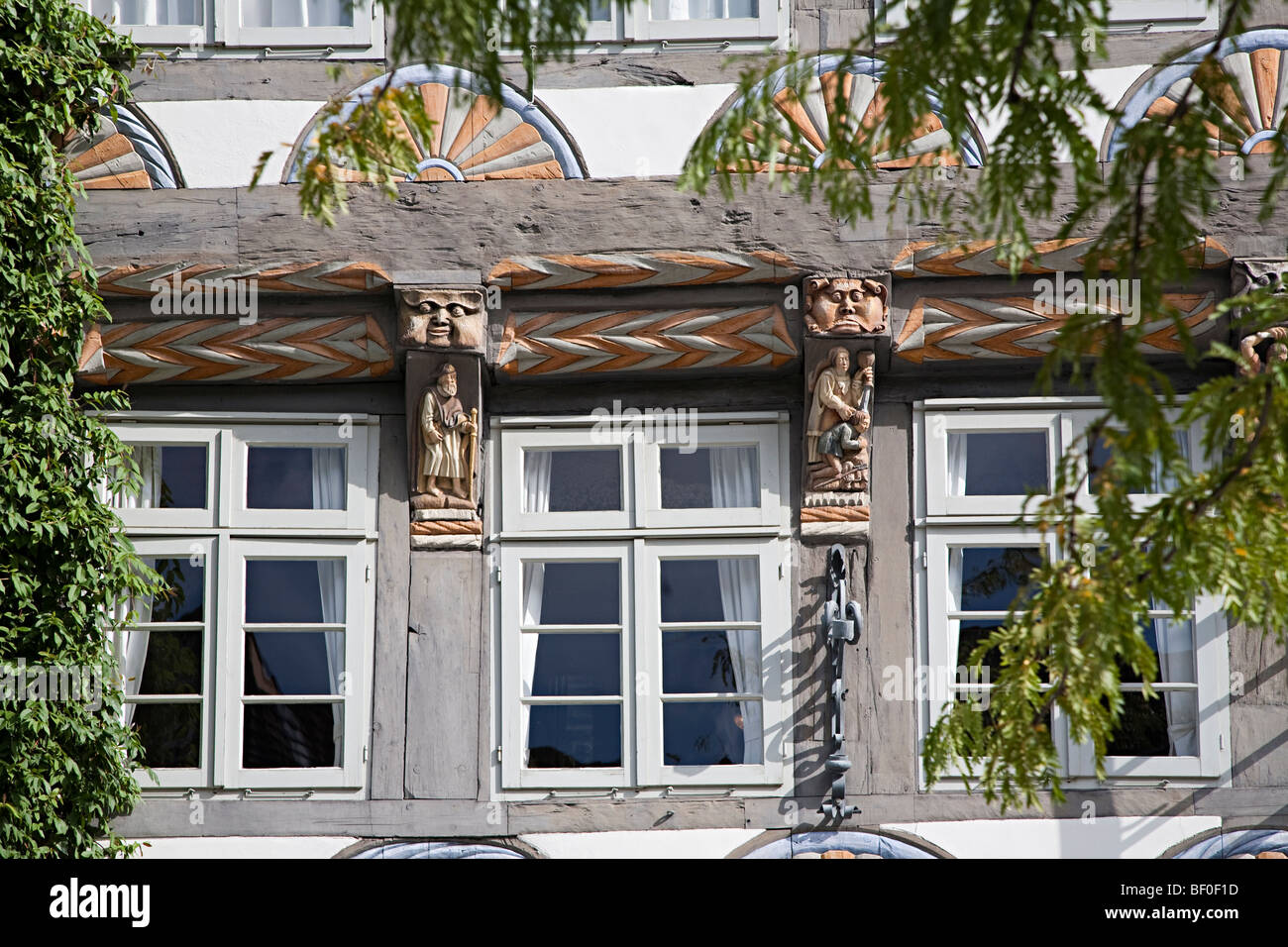 Faces carved into the Stiftsherrenhaus or Capitular's House Hamelin Germany Stock Photo