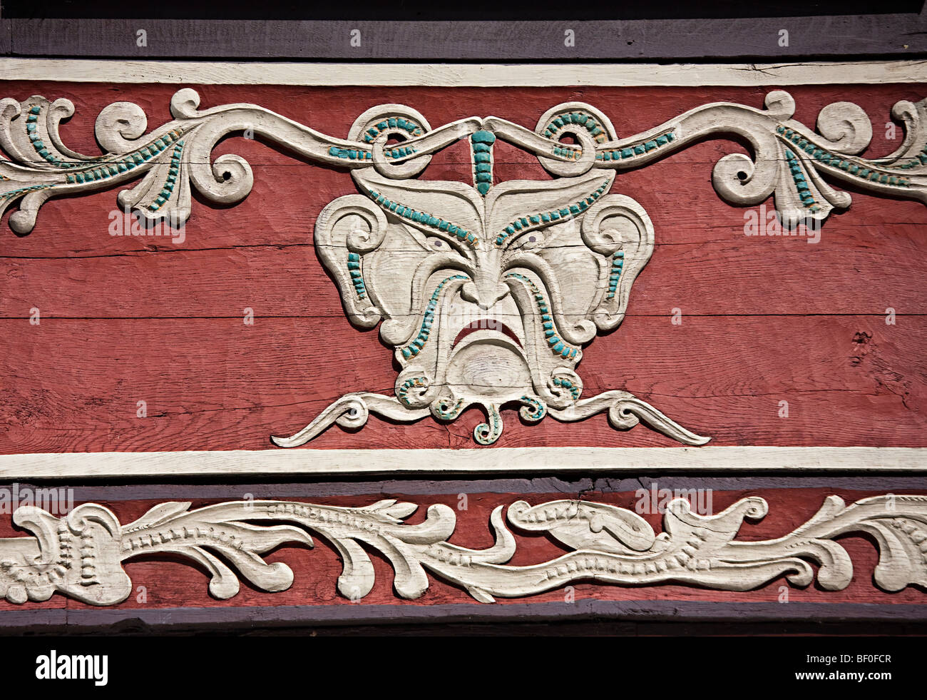 Unhappy face carved into wooden beam on house Hamelin Germany Stock Photo