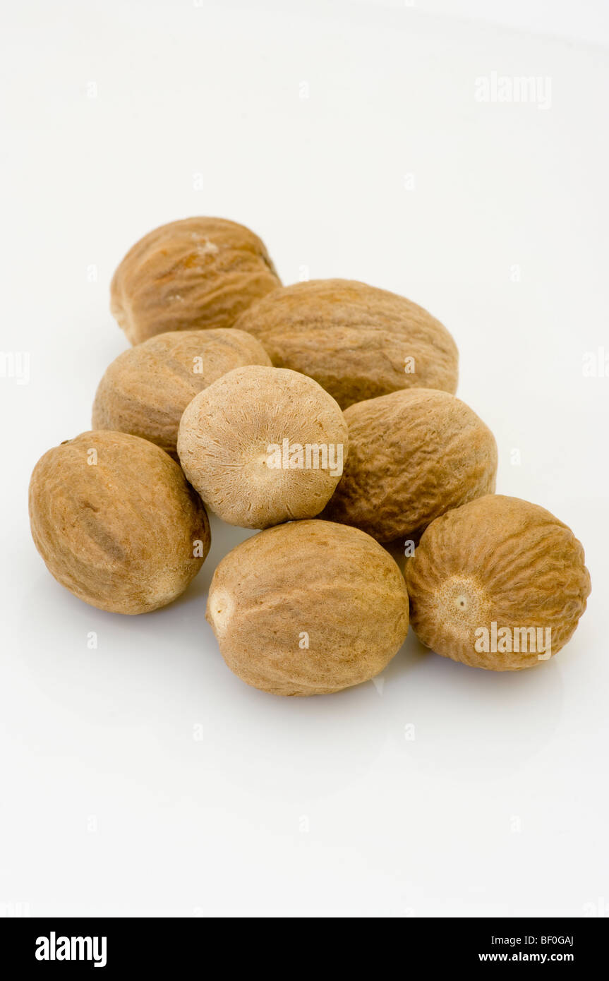 A Pile Of Whole Nutmegs On A White Background Stock Photo