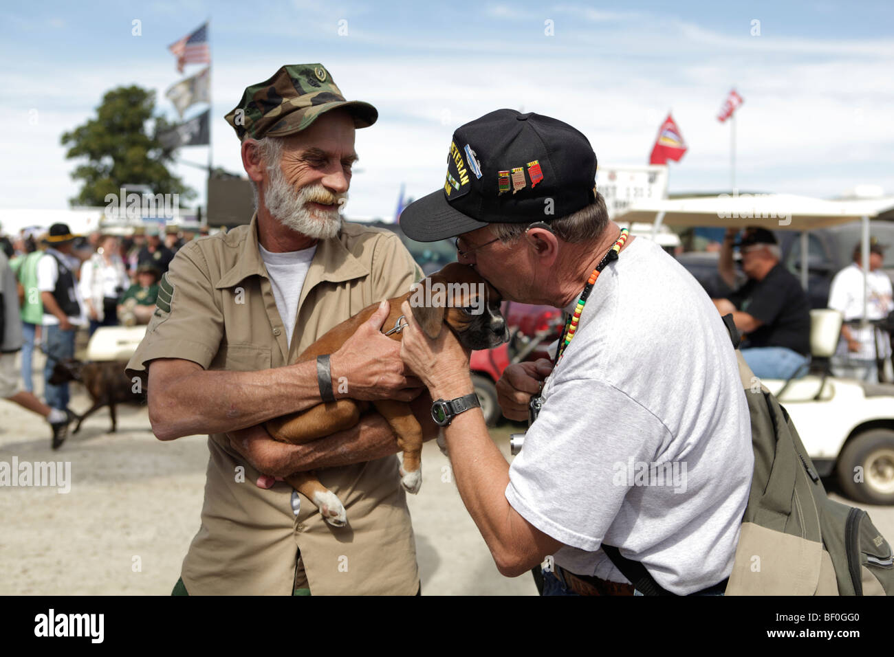 A Vietnam Veteran pets a dog at the Kokomo Vietnam Veterans reunion. Stock Photo