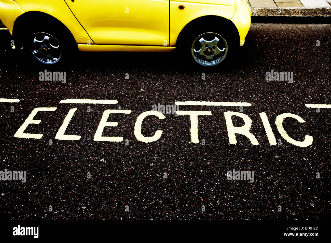 An Electric Car charges up at one of Westminster's 'Juice Point'  parking bays Stock Photo